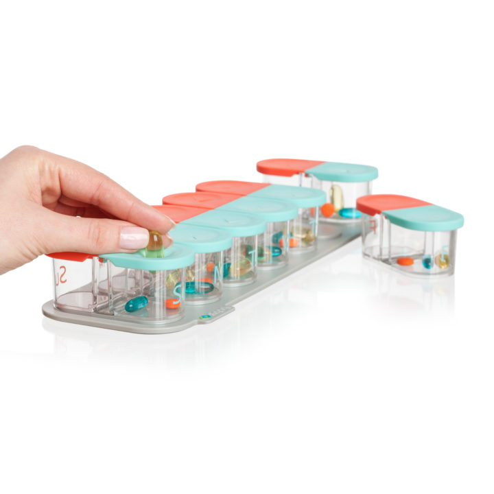 Sagely weekly pill organizer in coral and red
